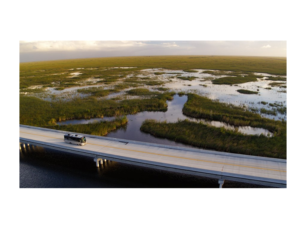Adventurer driving over bridge in Everglades