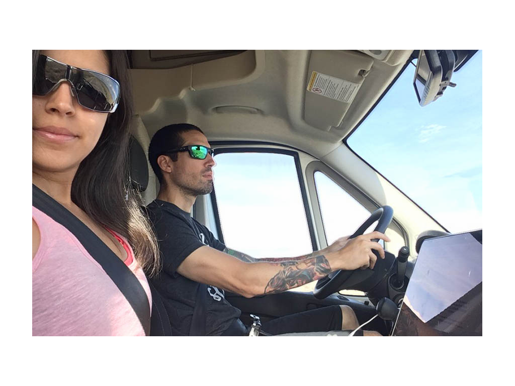 Nadia taking selfie with Jon while Jon drives the Trend