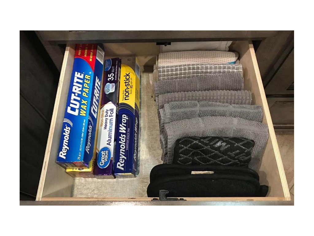 Kitchen drawer with foil and plastic wrap and towels folded using KonMari method