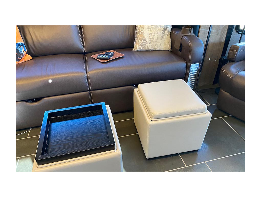 Two tan storage ottomans in front of brown sofa