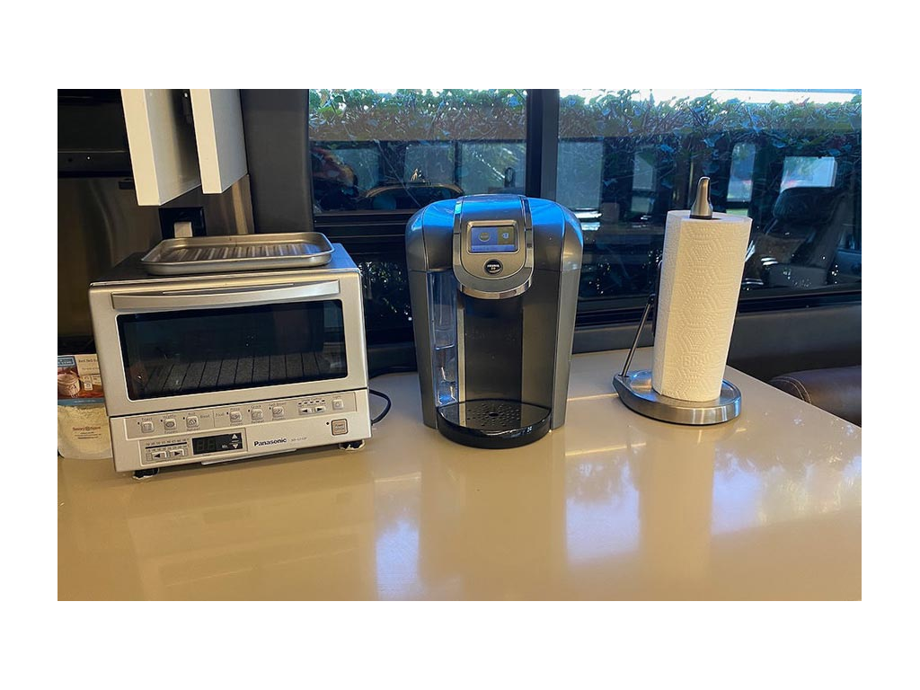Toaster oven, coffee maker, and paper towel holder sitting on countertop