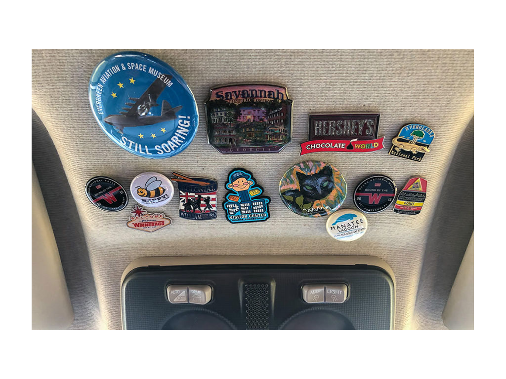 Collection of pins and patches in cab of Travato