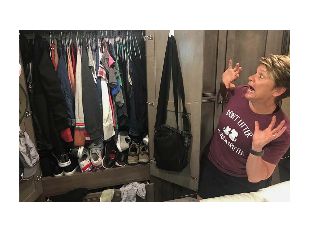 Lin looking terrified at a closet full of unorganized clothes
