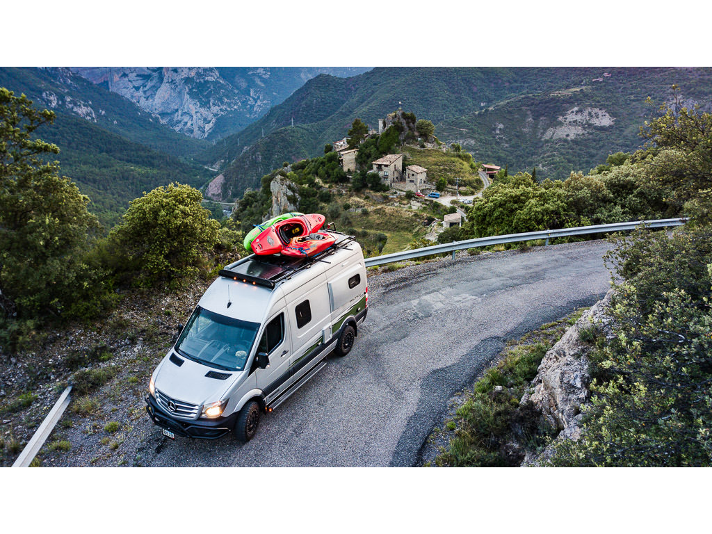 Winnebago Revel being driven in Spain with a valley and town below