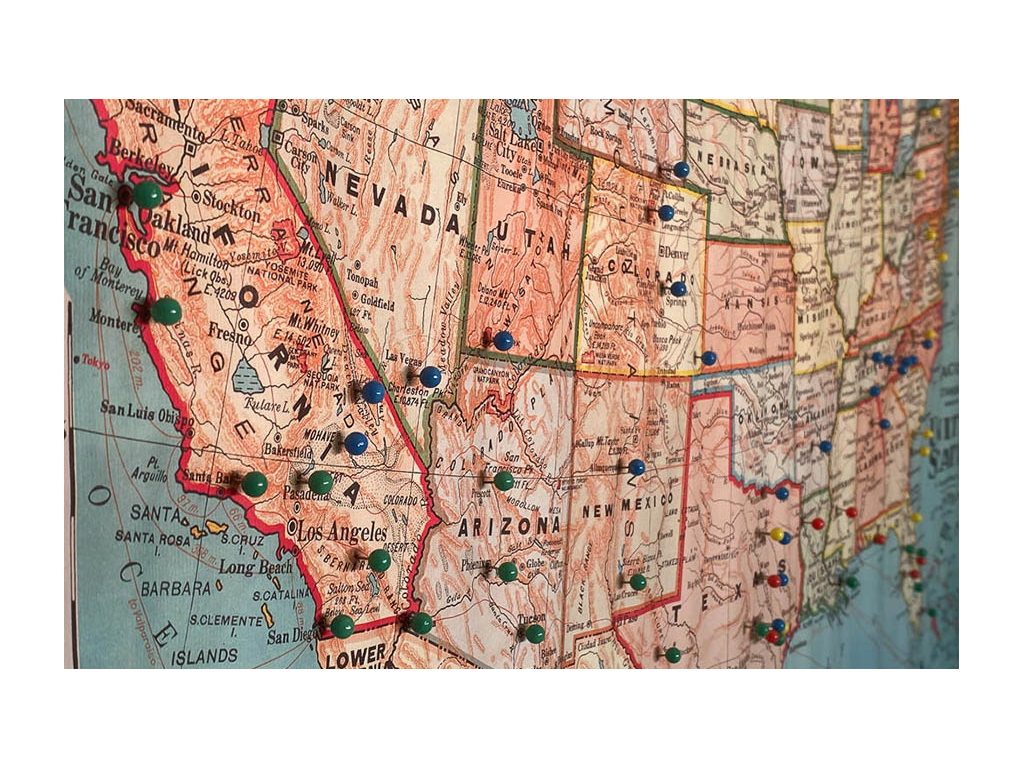 Map of the United States with push pins to mark traveled to locations.