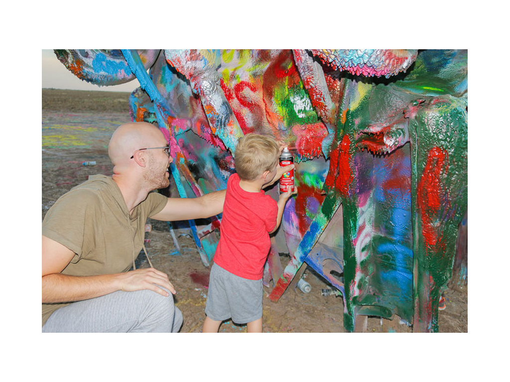 Nic with one of the boys painting at Cadillac Ranch