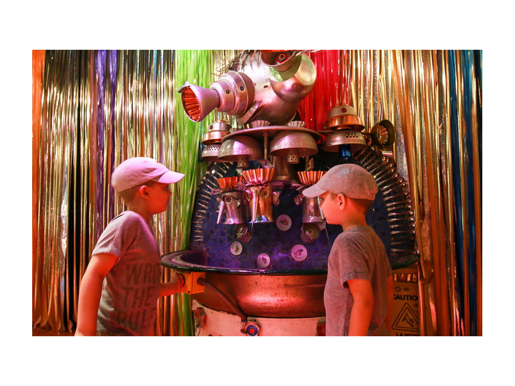 The boys looking at a fun machine at the Kaleidoscope