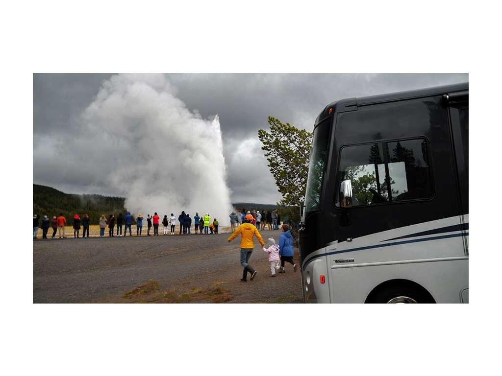 Kelly and kids running out of Adventurer towards crowd of people gathered around a geyser