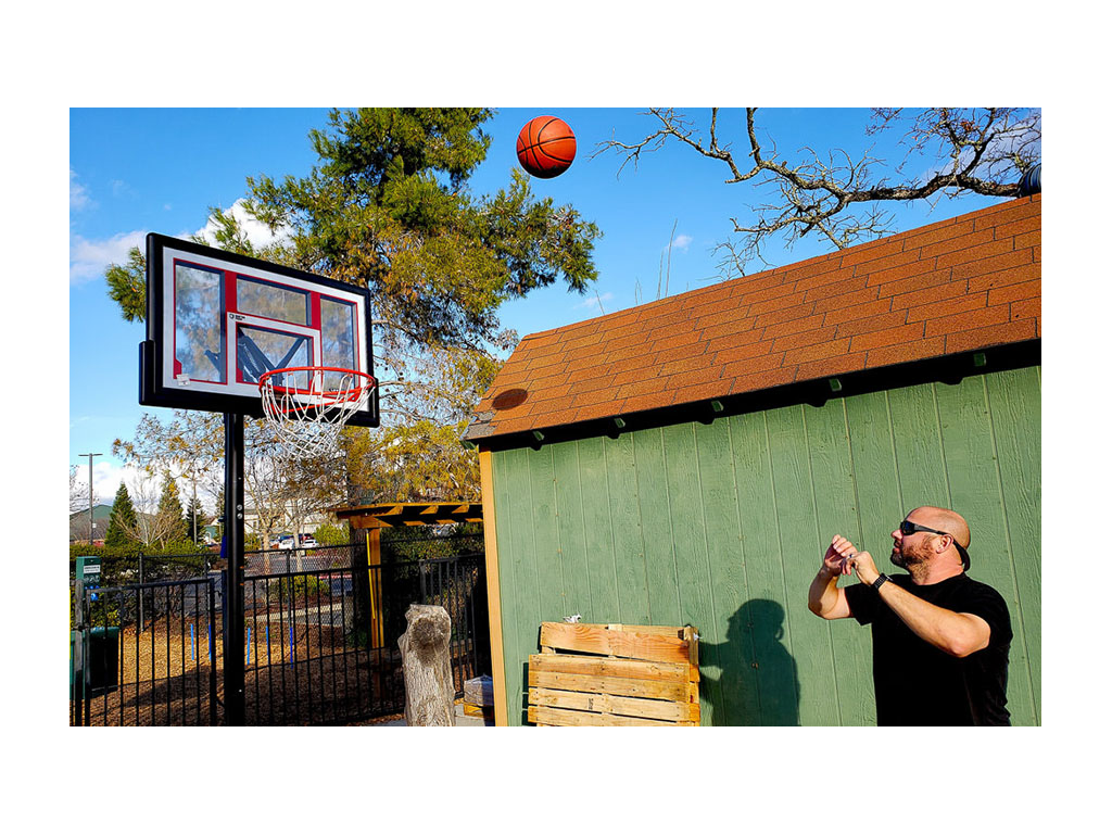 Kenny shooting basketball into hoop