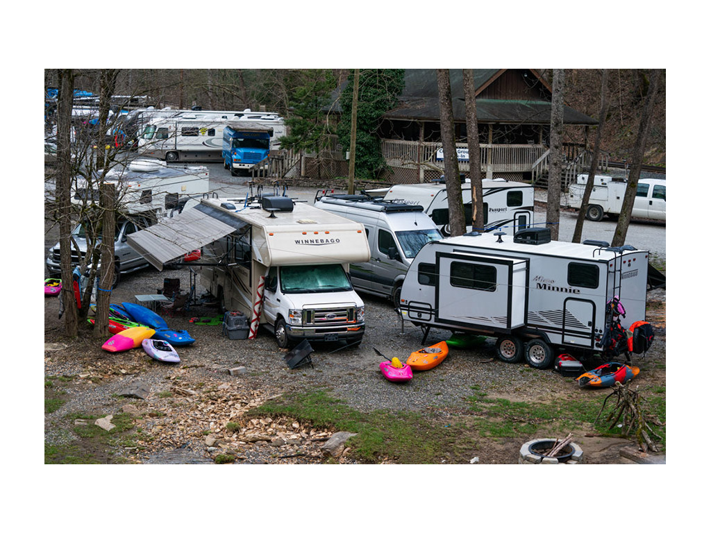 Lot full of RVs with kayaks on ground