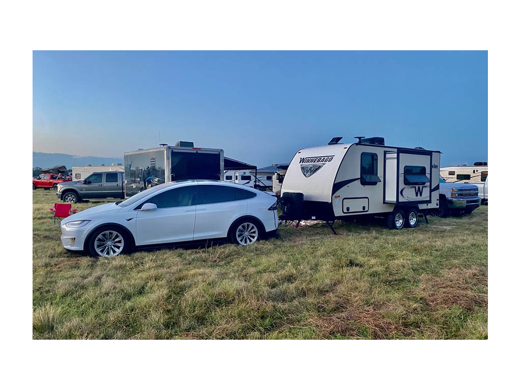 Tesla and Micro Minnie parked on grass