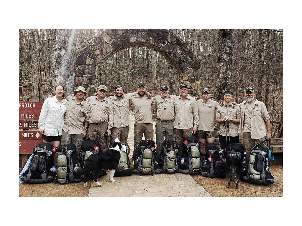 Warrior Expeditions group at trail head with gear 