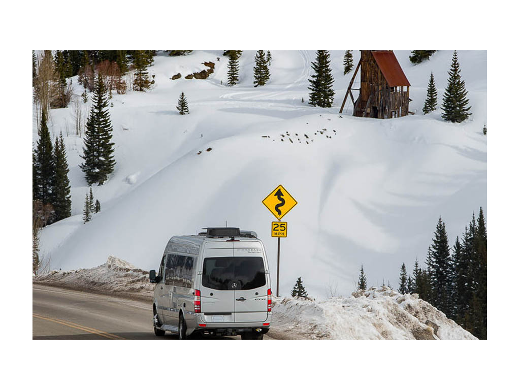 Winnebago Era driving down snow covered road