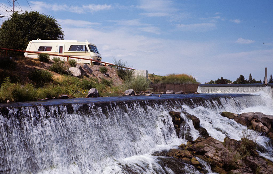 Old RV next to waterfall in Laramie