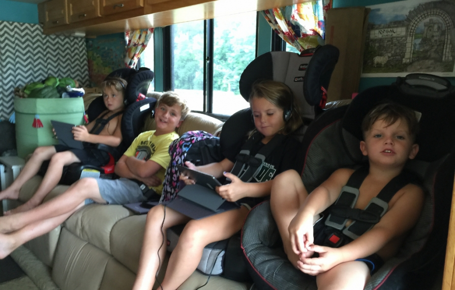 Four kids buckled in along the couch.