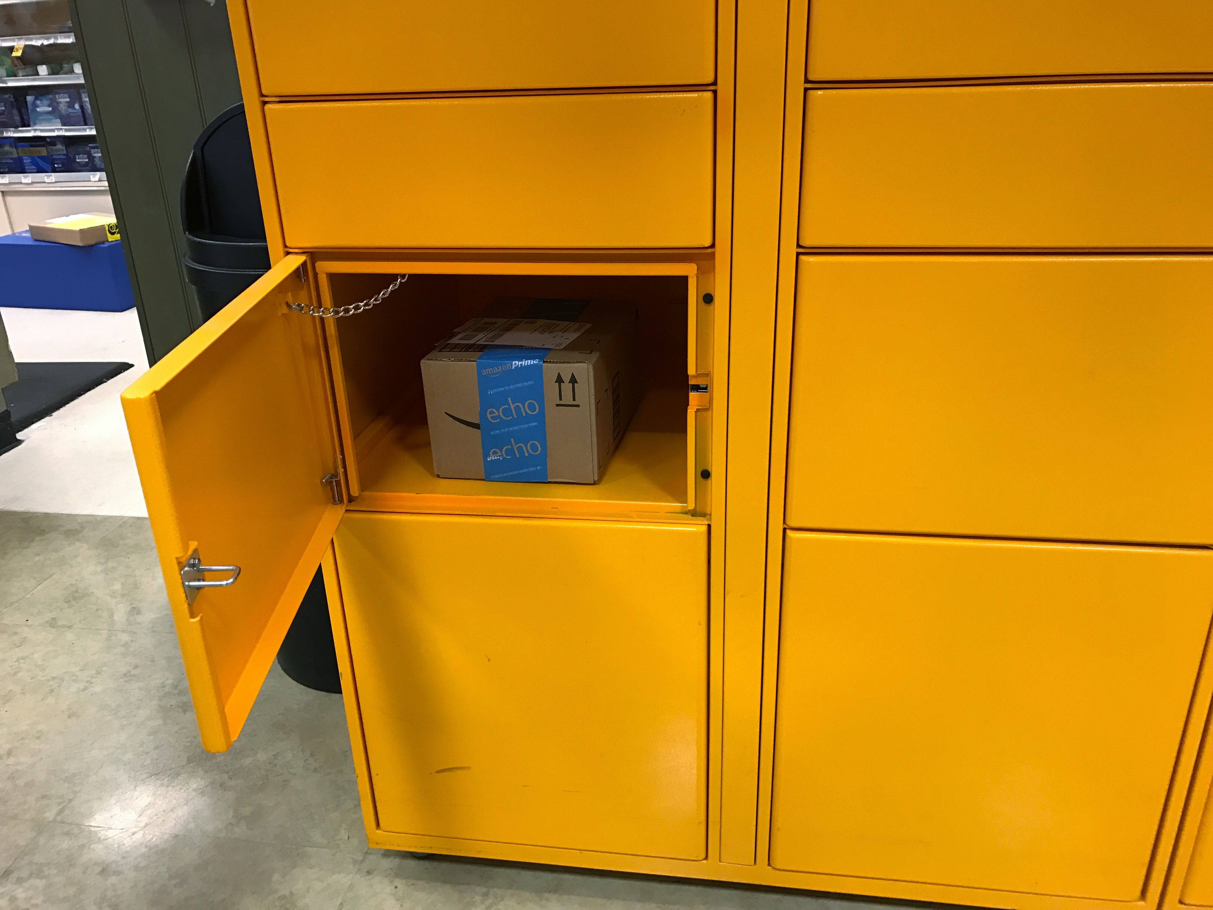 Detail view of opened Amazon locker with package inside the compartment