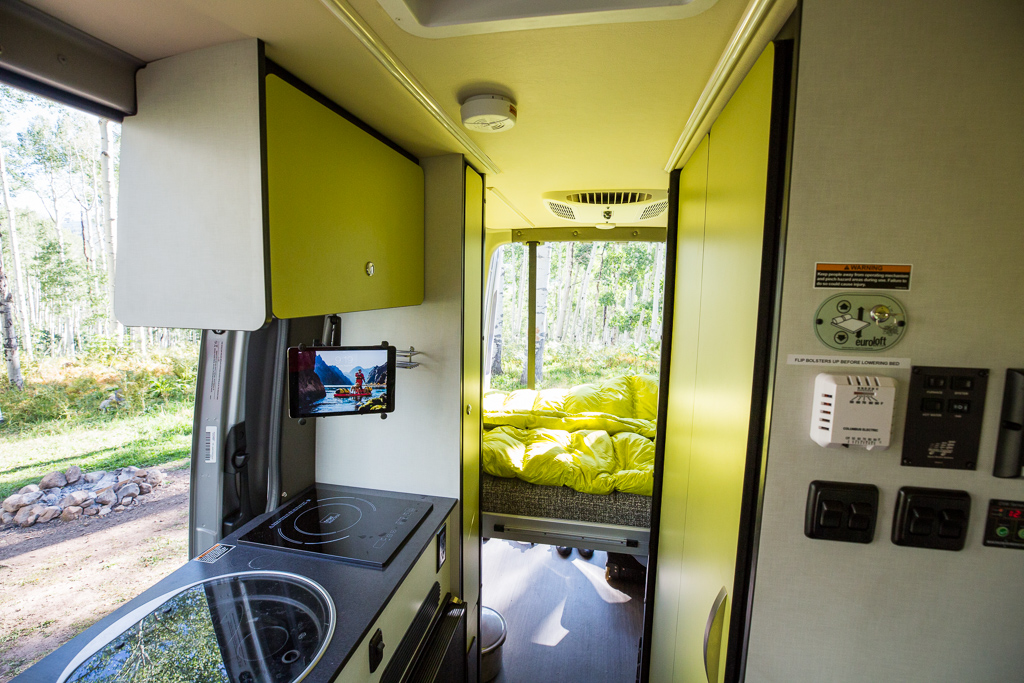 Winnebago Revel kitchenette and bed lowered in the back.