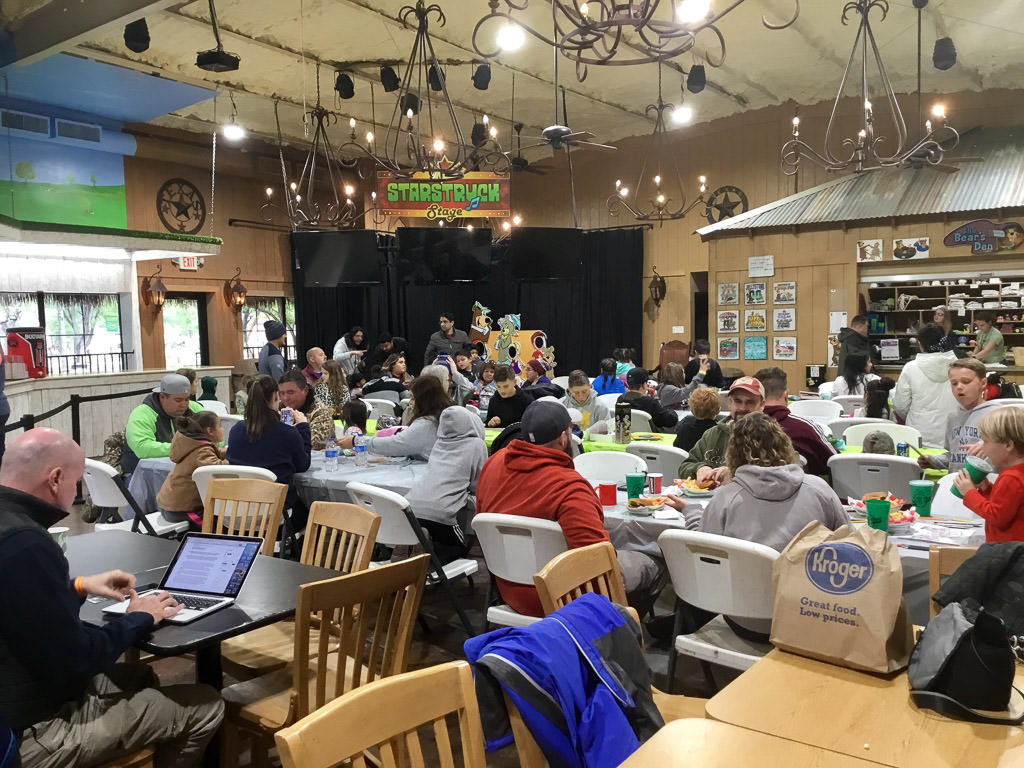People gathered in the indoor recreation space at the campground
