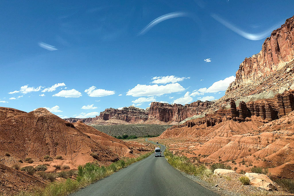 Van driving on road through canyon