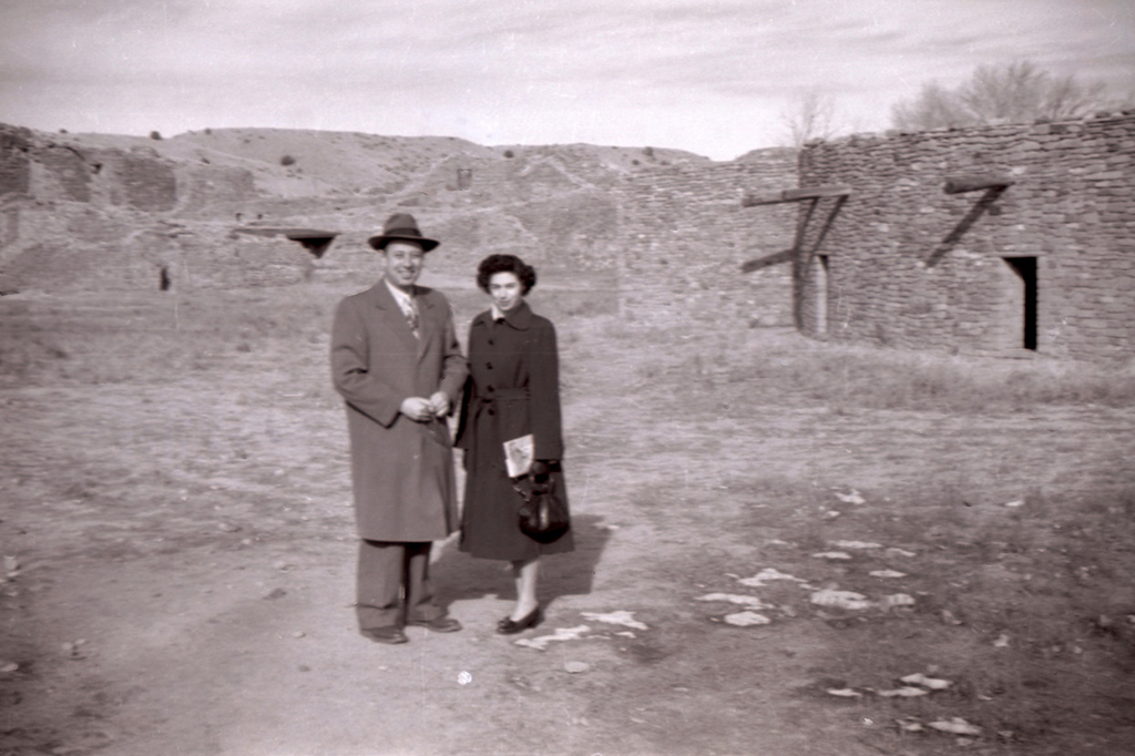 Old photo of Don's parents standing in front of building ruins.