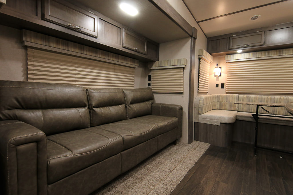 Couch and dinette of Winnebago Minnie Plus Fifth Wheel.