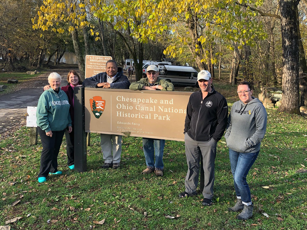 Travato owners in front of Chesapeake and Ohio Canal National Historic Park sign