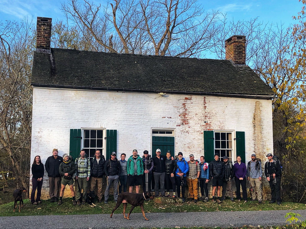 Warrior Expeditions group standing in front of white building before Veterans's Day hike