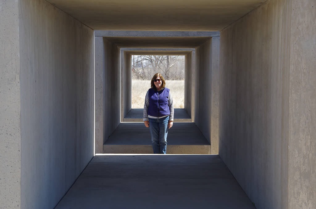 Woman posing in the concrete cube art.