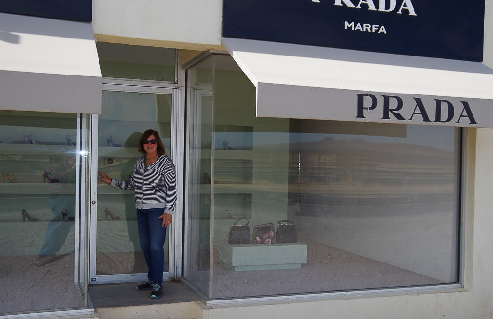 Woman in front of Prada store.