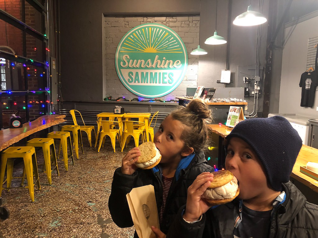 Kids eating huge ice cream sandwiches at Sunshine Sammies.