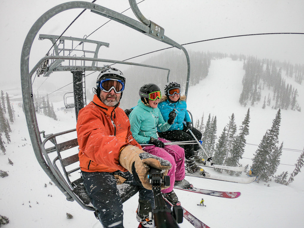 Family of three on a ski lift.