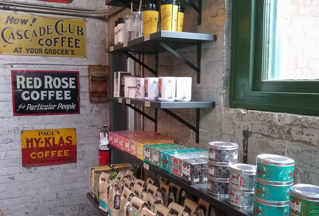 Coffee shop shelves with various types of coffee and tea.
