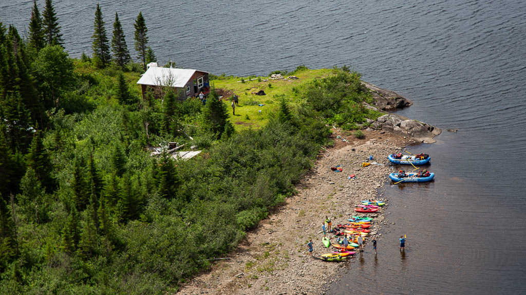 Kayaks lined along the water at the first camping spot.