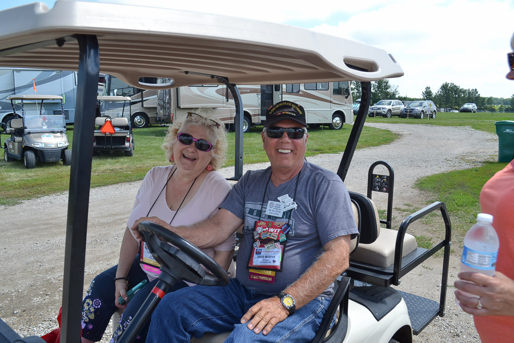 Two rally attendees on their golf cart