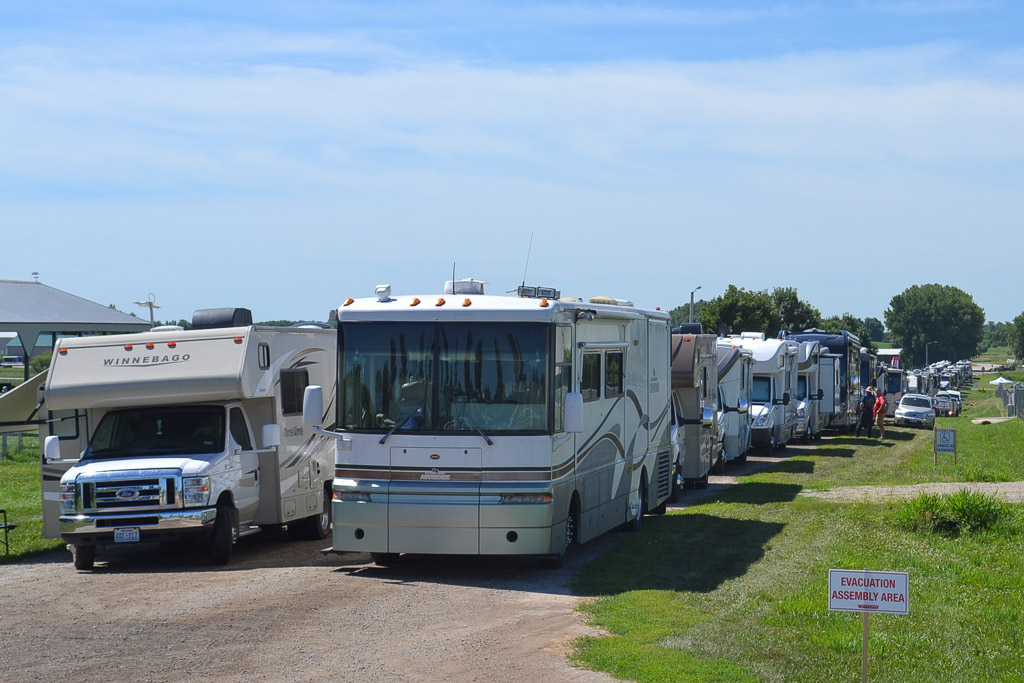 Winnebago motorhomes lined up preparing to enter the rally grounds