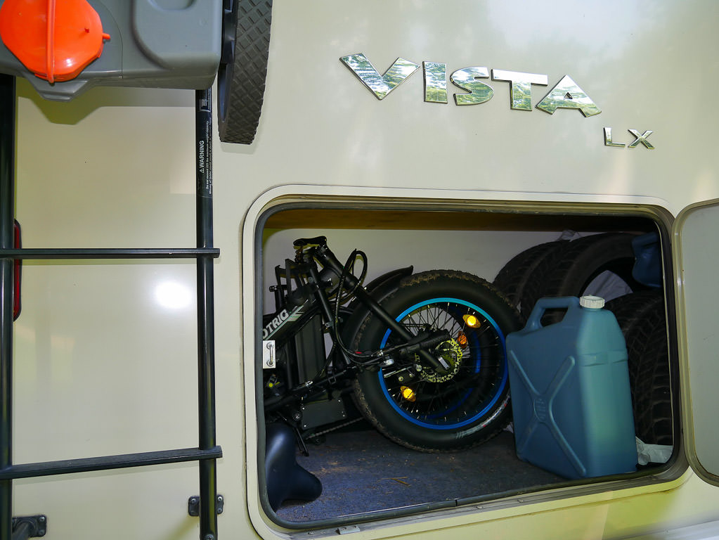 Fold-able electric bike placed in exterior storage compartment of RV