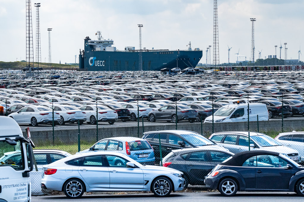 Parking lots full of cars waiting to be loaded onto a freighter.