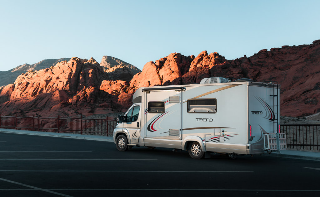 Winnebago Trend in parking lot with Red Rock Canyon in the background.
