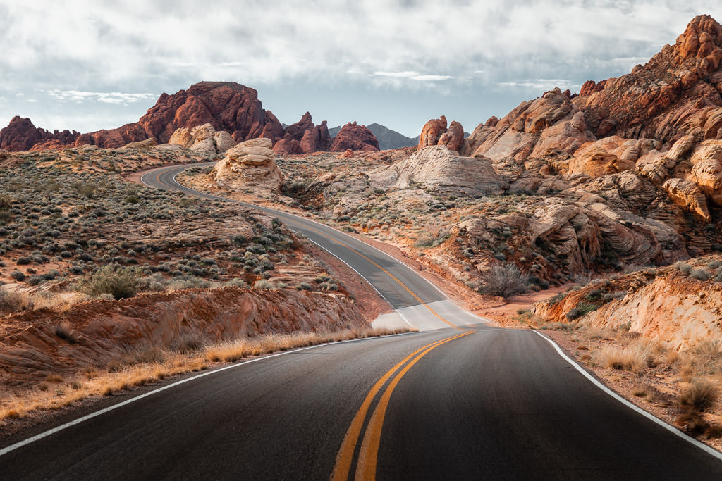 Empty road winding along the edge of Red Rock Canyon.